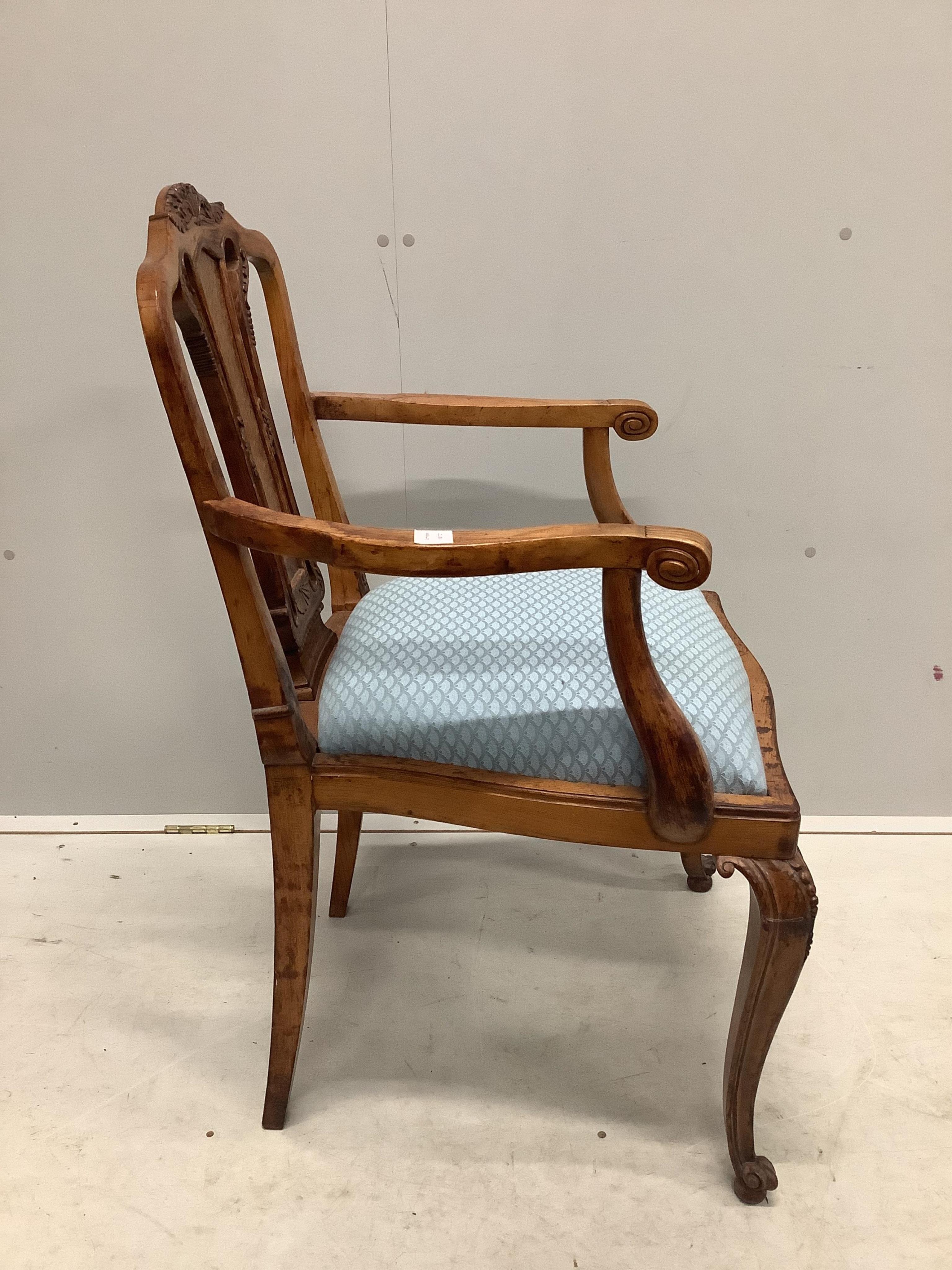 An early 20th century French carved beech and walnut elbow chair, width 56cm, depth 51cm, height 98cm. Condition - fair